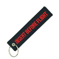 Klíčenka INSERT BEFORE FLIGHT černá